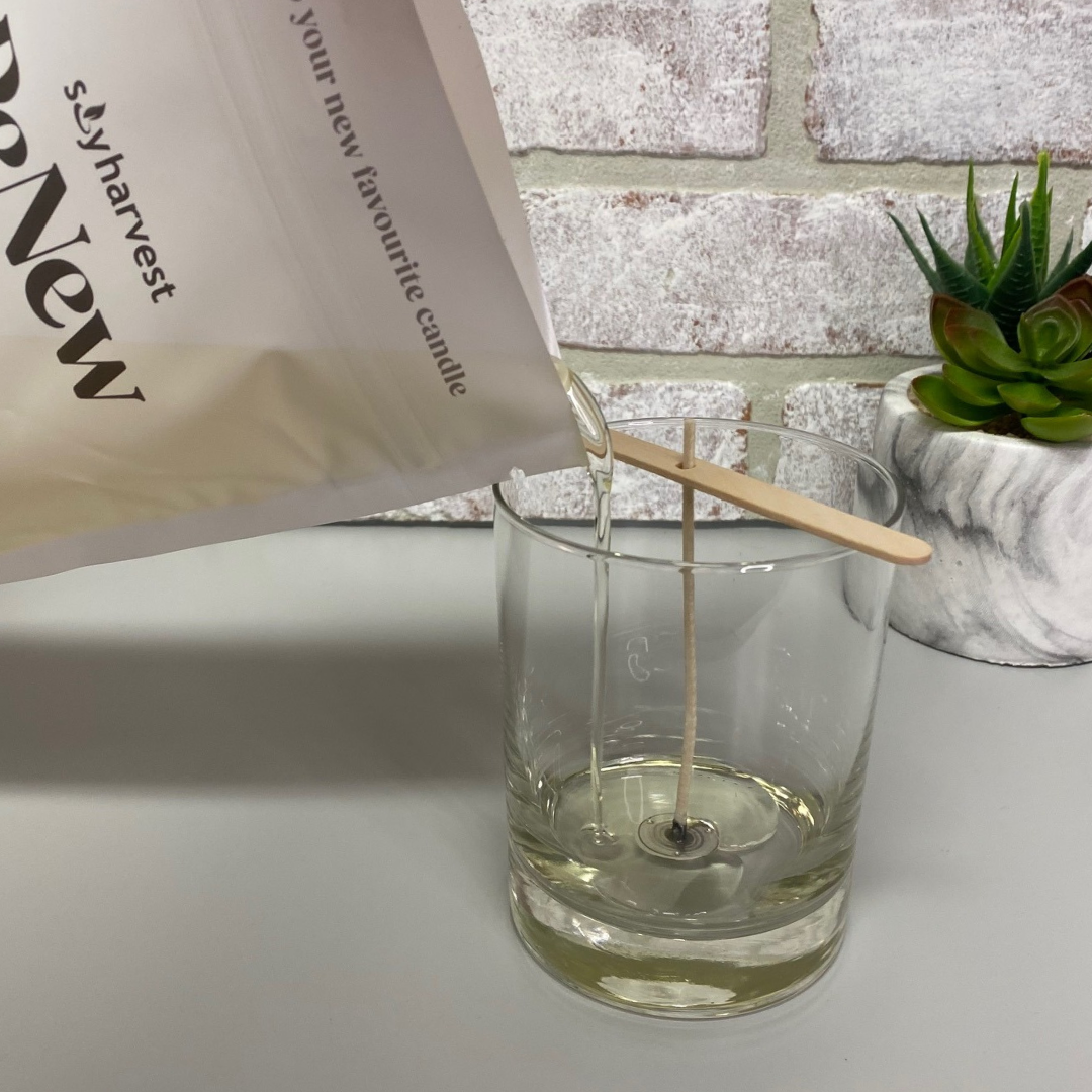 liquid wax pouring into candle glass