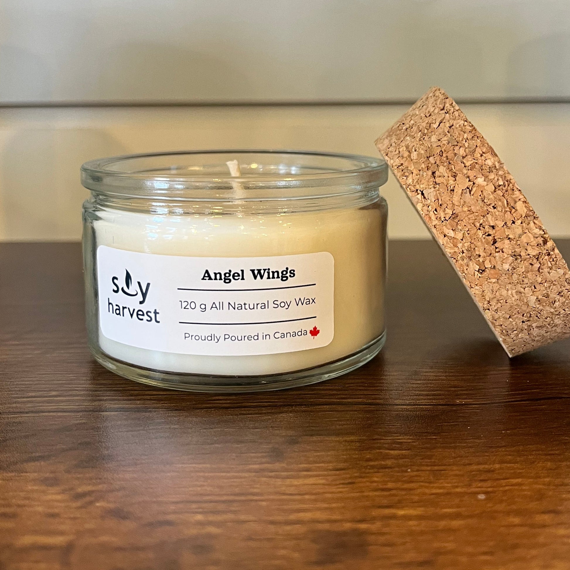 Small glass jar with a cork lid on a wooden surface