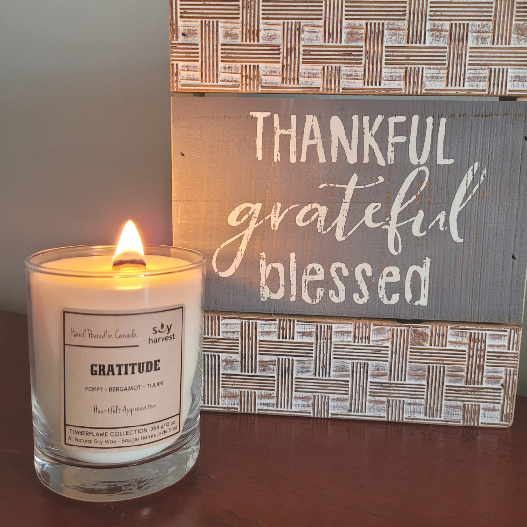  wooden wick all natural soy wax candle  lit beside sign thankful grateful blessed