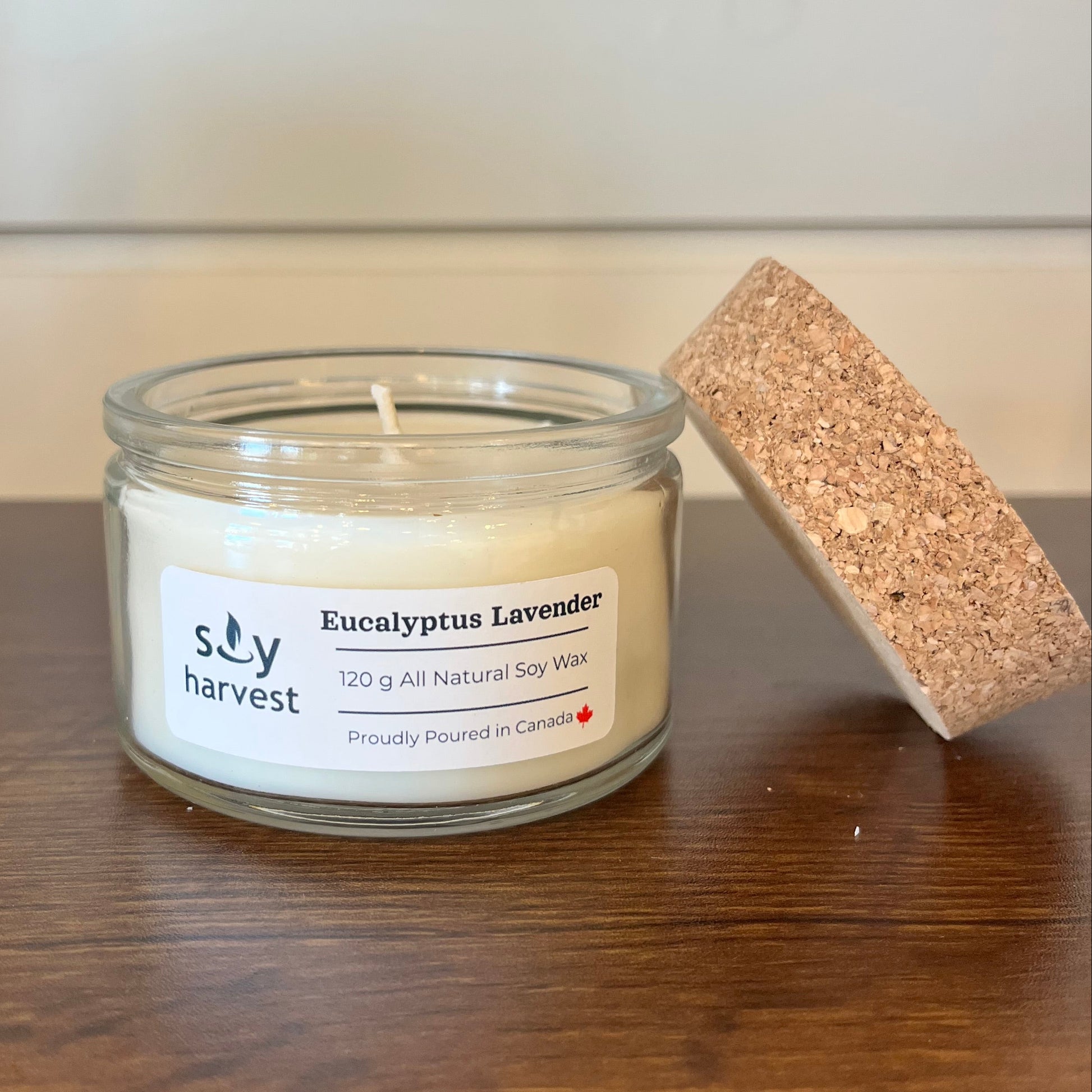 Jar of candle with a cork lid on a wooden surface