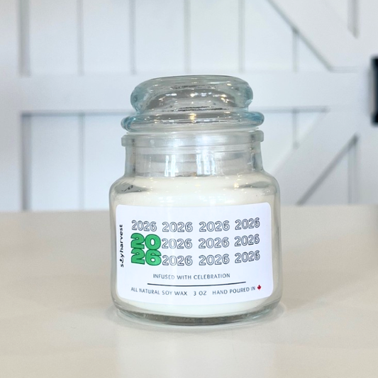 Glass jar candle with a label on a white surface