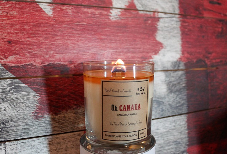  wooden wick all natural soy wax candle  sitting in front of canada flag
